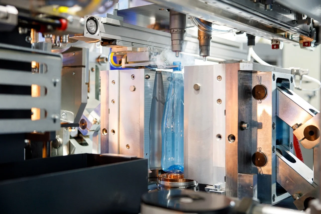 Close-up view of advanced plastic injection molding machine in operation with precision components